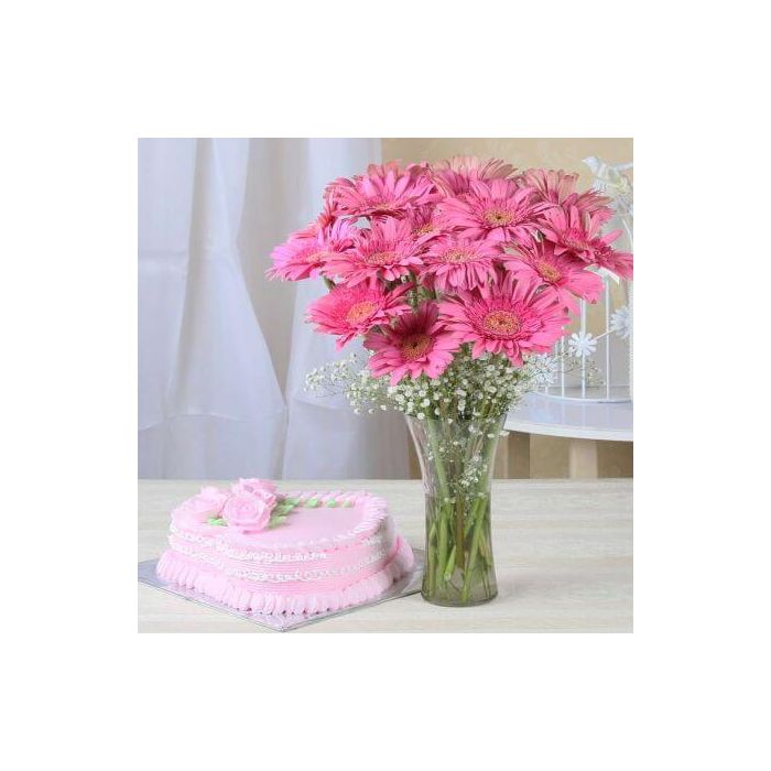 A 1 Kg strawberry cake accompanied by a bunch of fresh pink gerberas. A 1 Kg strawberry cake accompanied by a bunch of fresh pink gerberas.